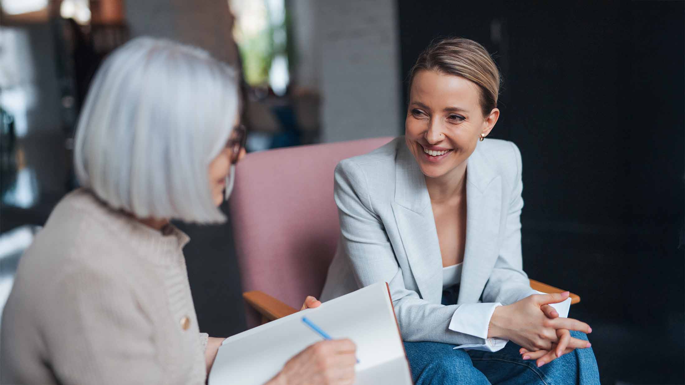 Woman sat in chair discussing her anxieties with her psychologist