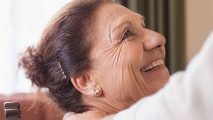 A woman smiles at her helper