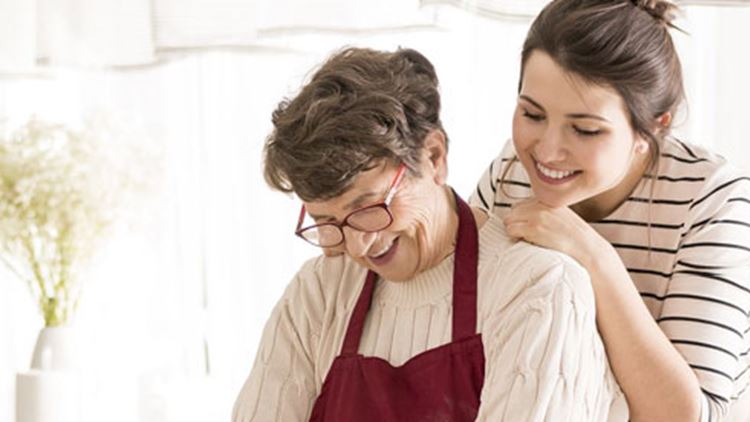 A mother and her daughter preparing a picnic food in a kitchen