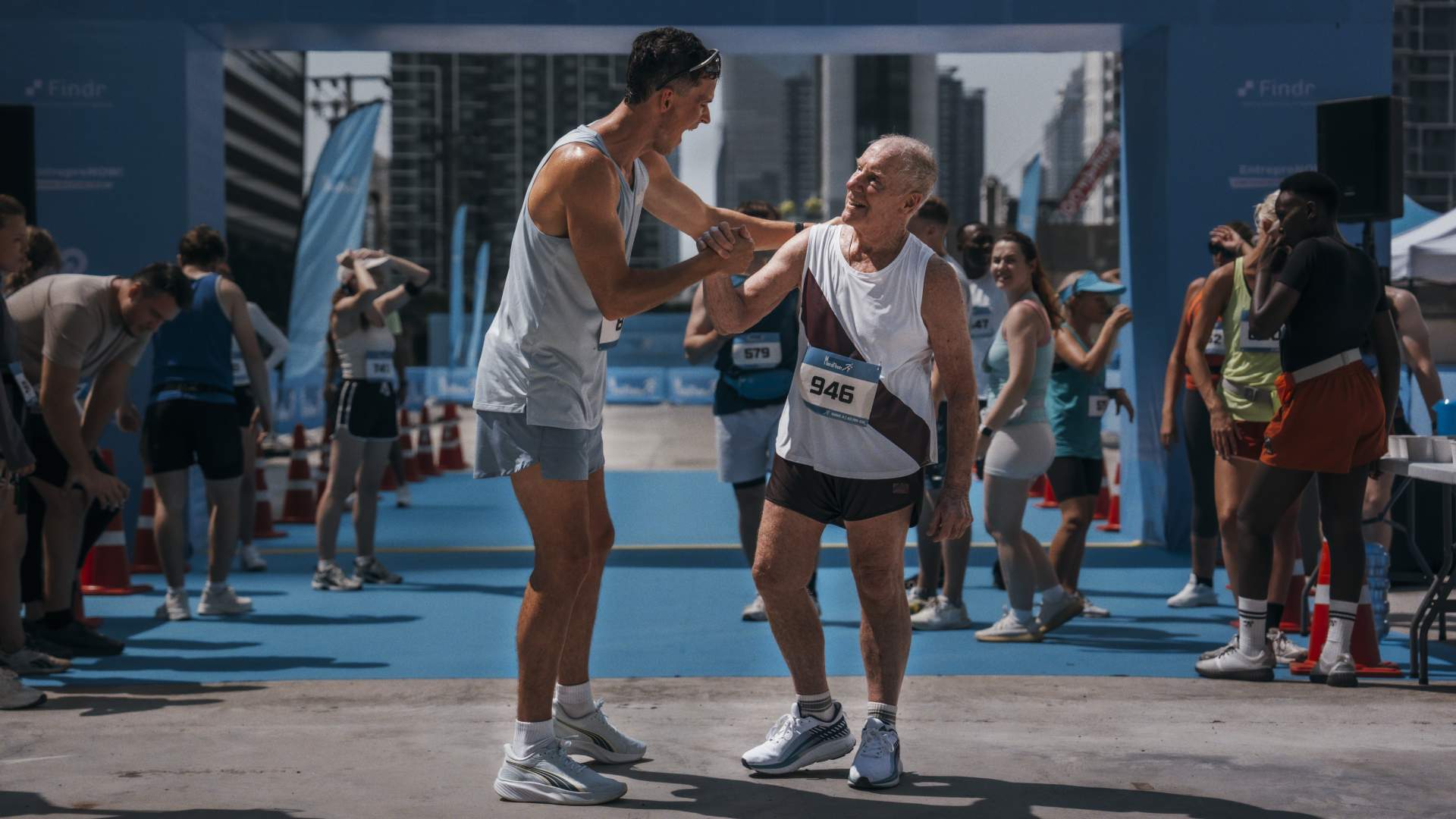Young and old marathon runners congratulating each other
