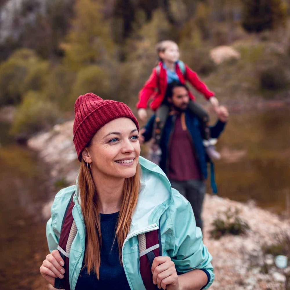 Family hiking next to a lake