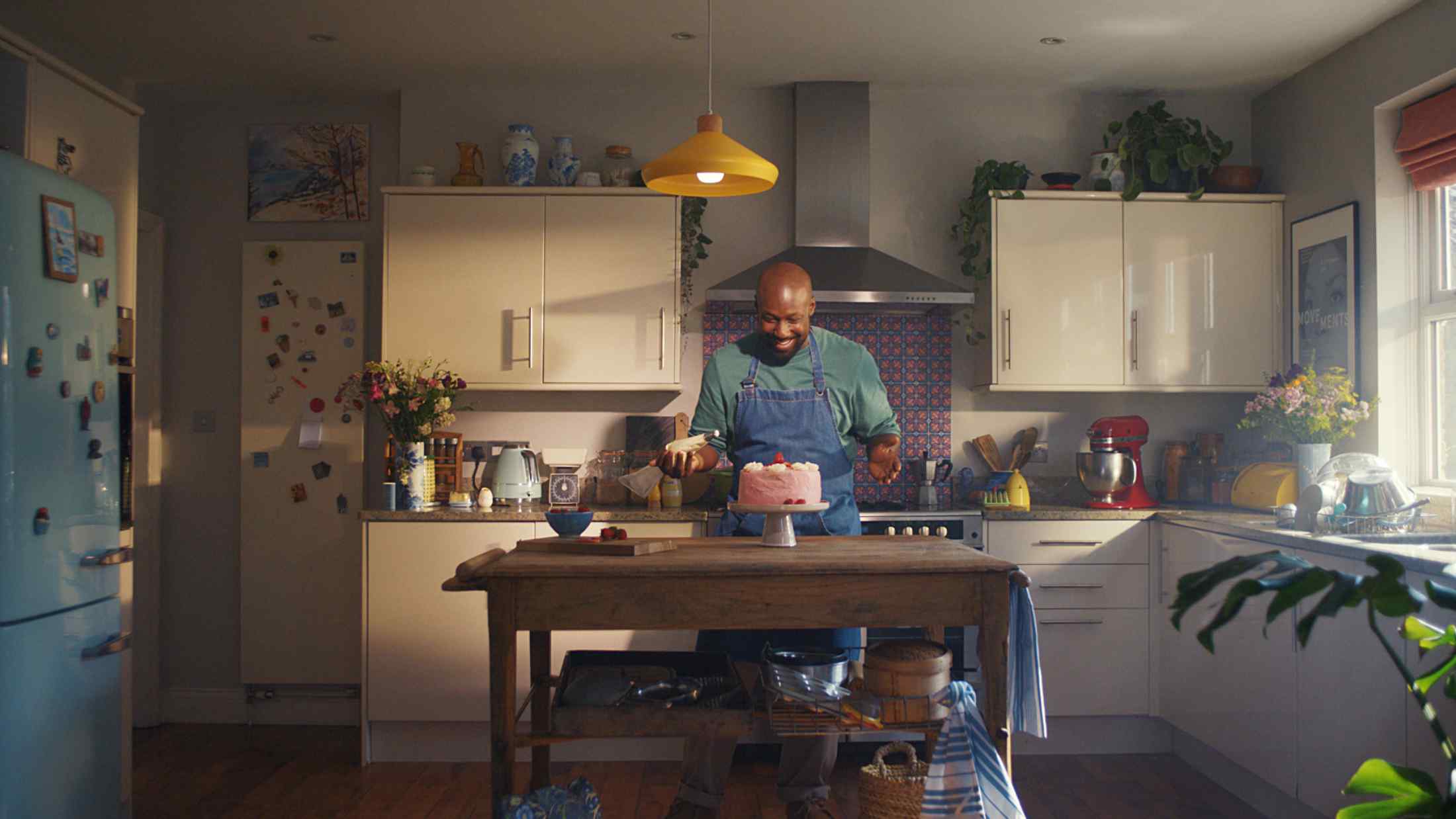 Man decorating a cake in his kitchen