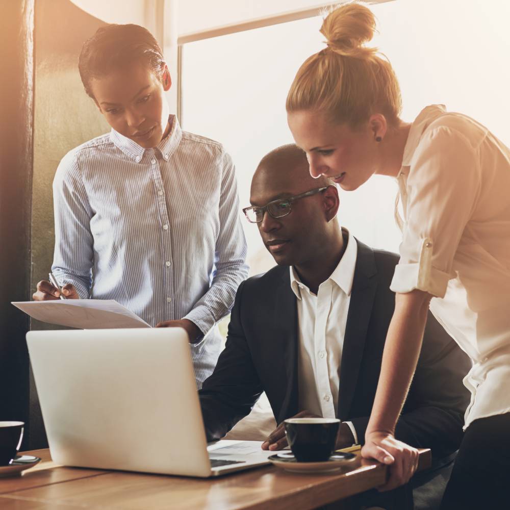 Group of entrepreneurs working using a laptop