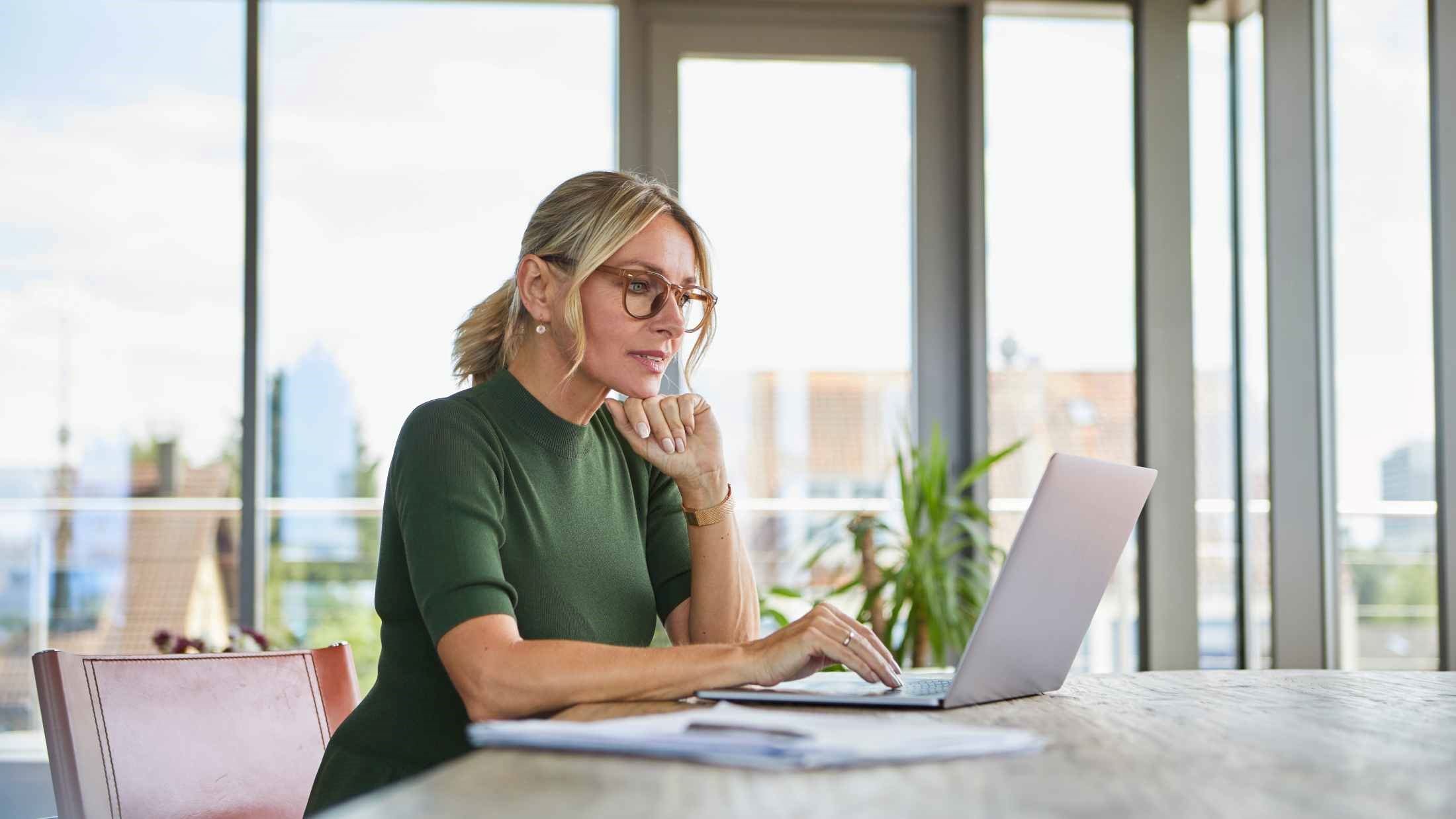 Mature woman using laptop on table at home
