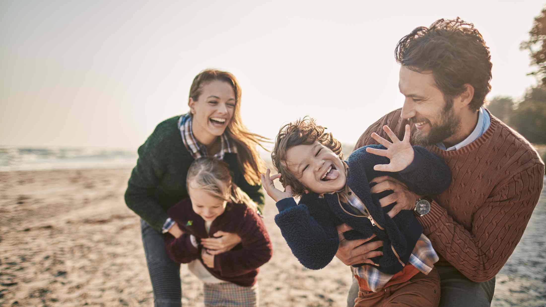 Close up of a happy family enjoying time on the beach