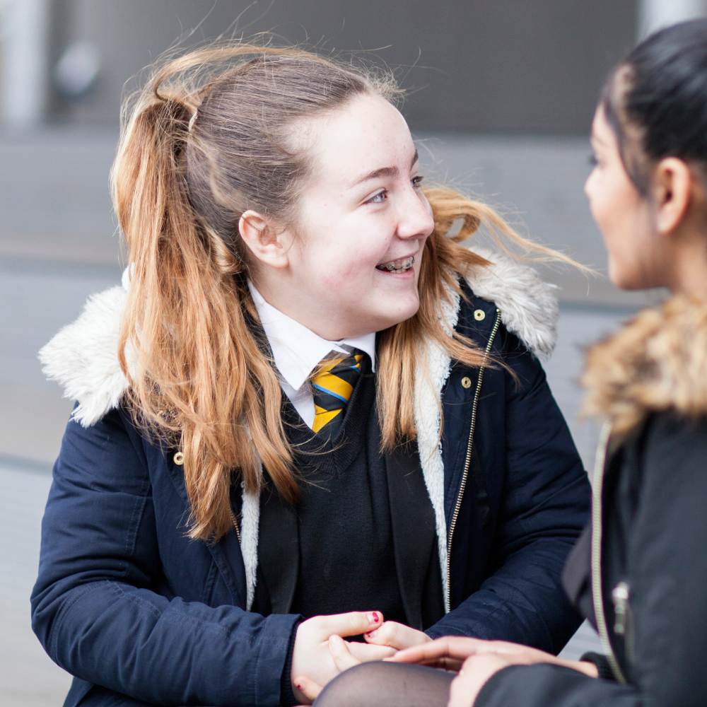 A high school student taking a break with smile in school