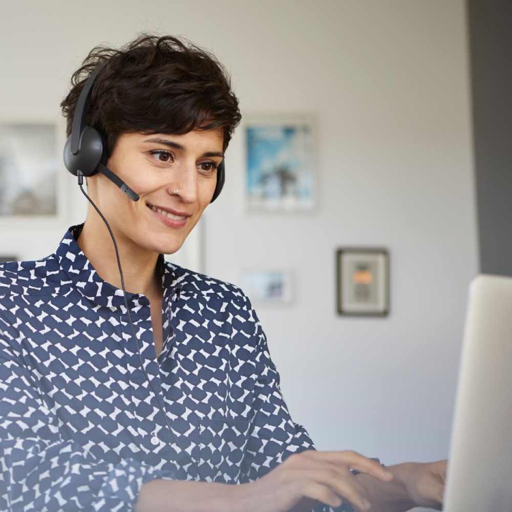 Woman wearing headset working on the computer