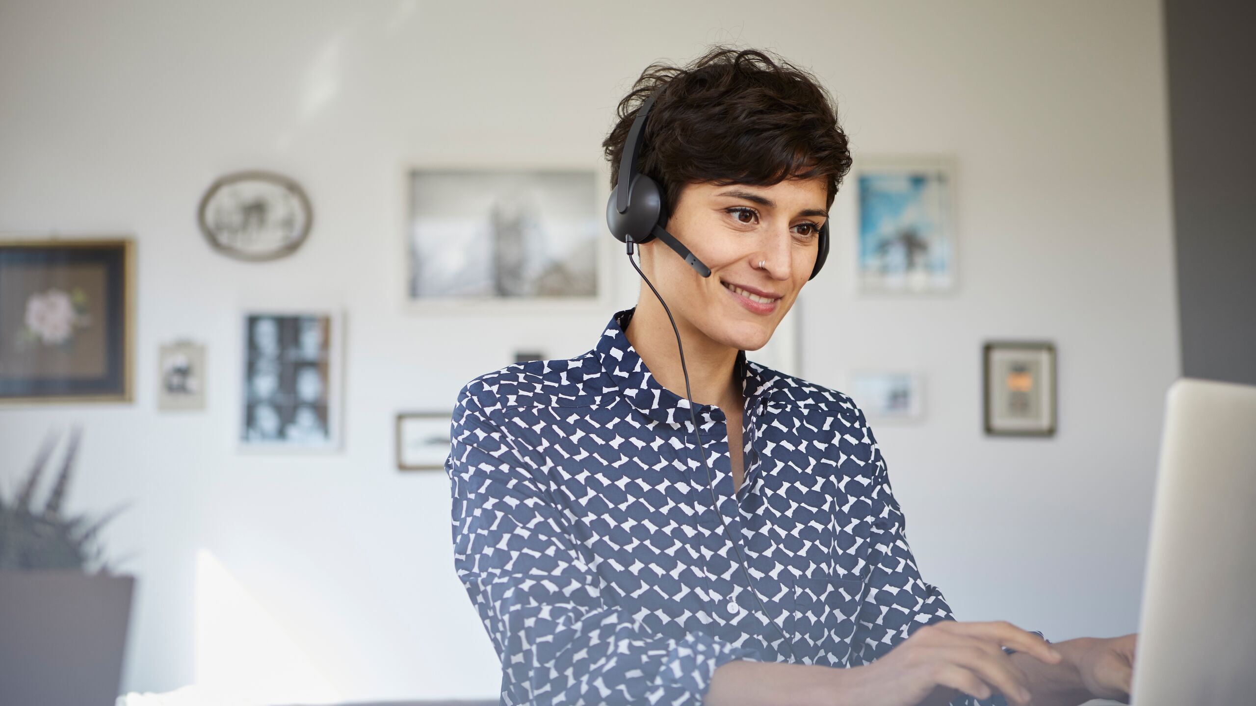 Woman wearing headset working on the computer