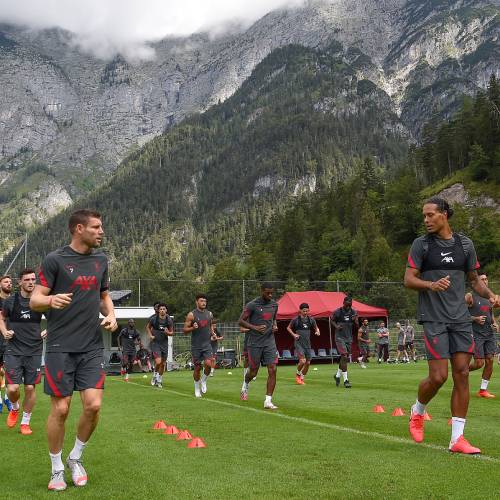 James Milner and Virgil van Dijk running against mountain backdrop