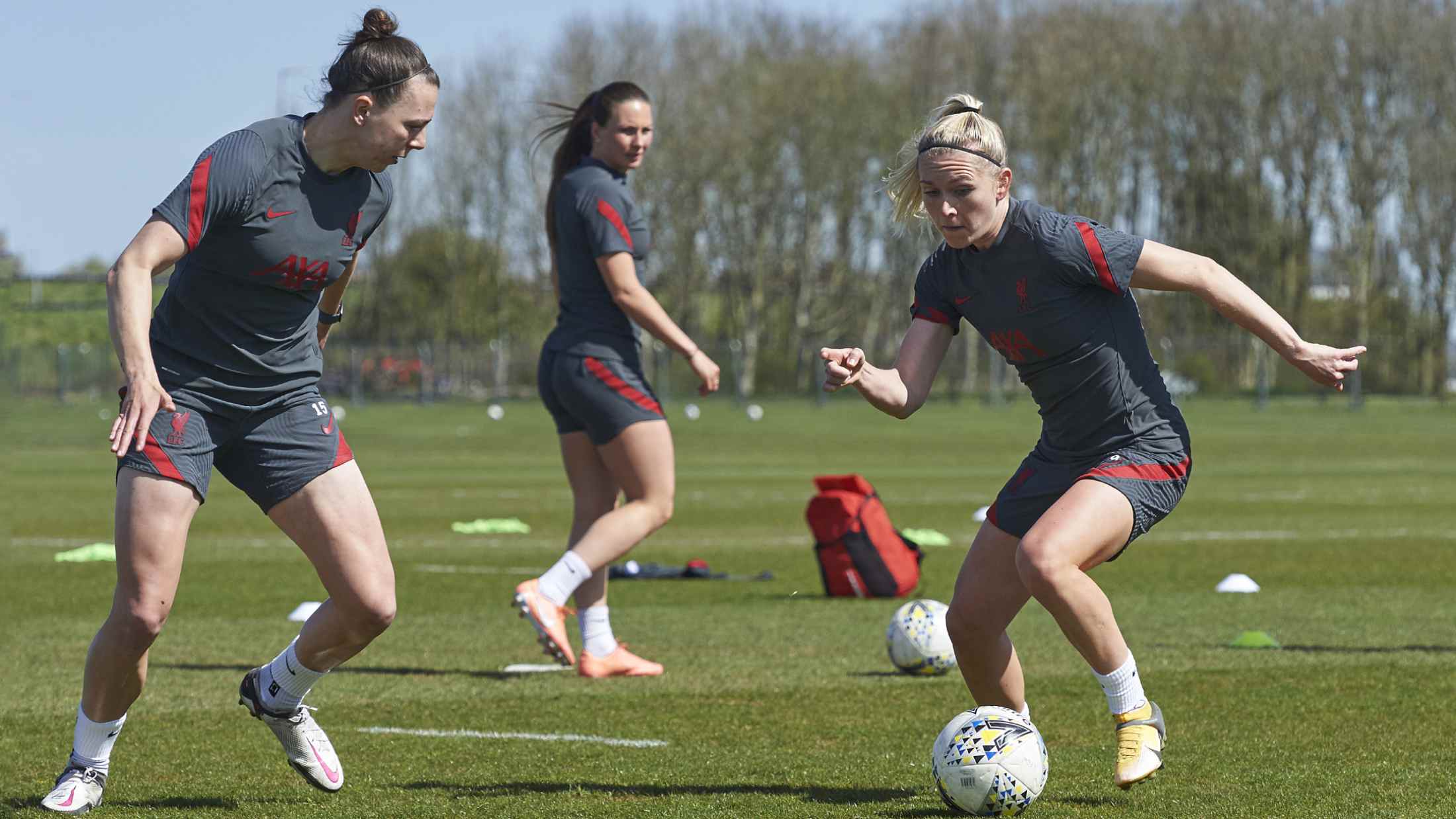 Liverpool Football Club women's player in training wearing their AXA sponsored training kit