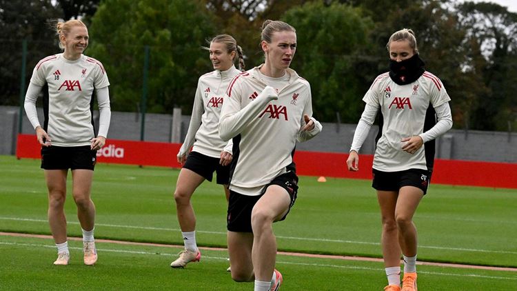 Liverpool Football Club Women's tema players wearing training kits with the AXA logo on the front