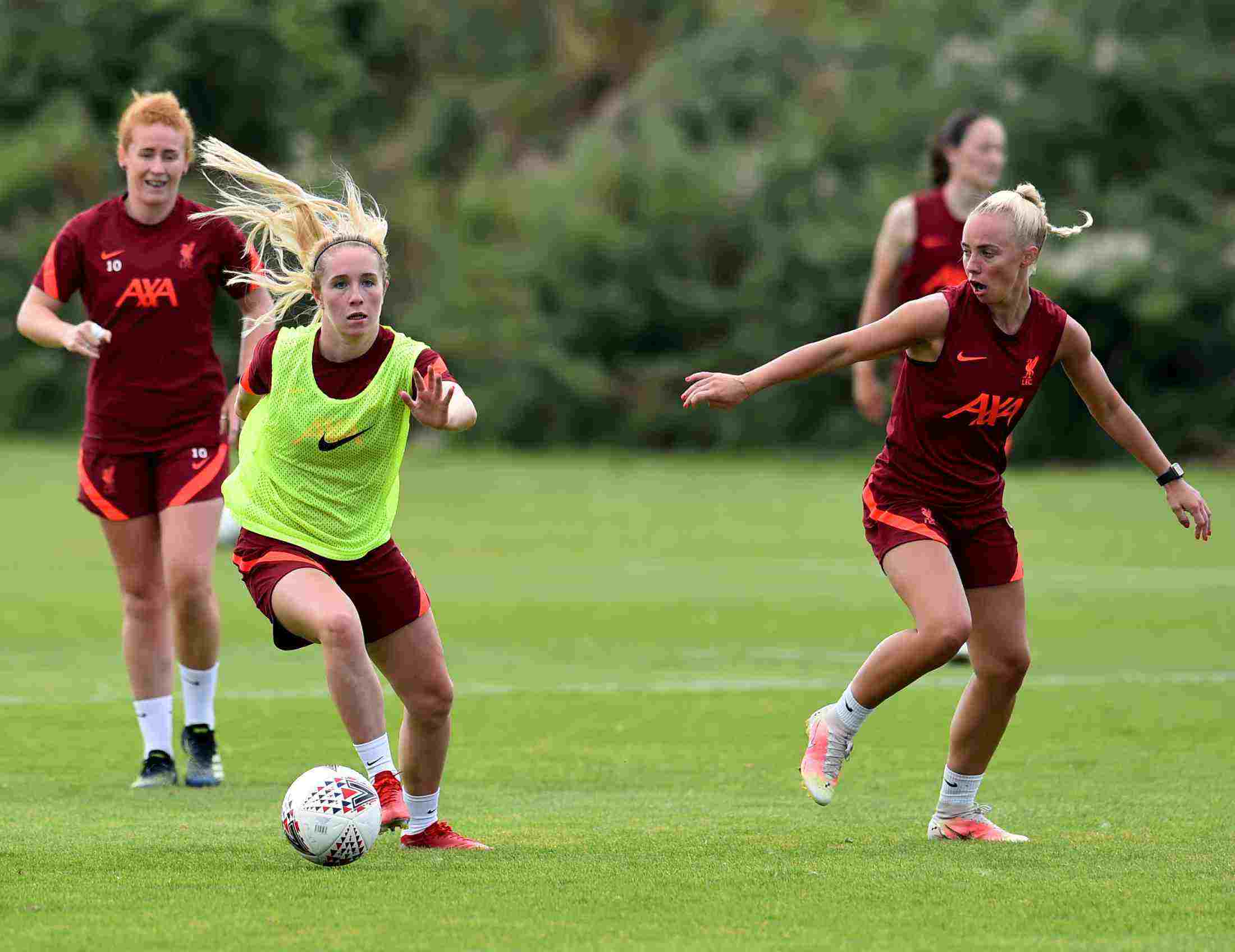 Liverpool Football Club women's player in training wearing their AXA sponsored training kit