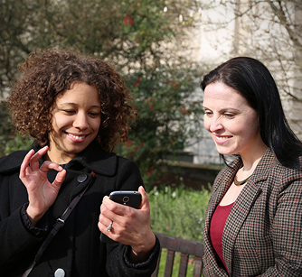 Two females working on a mobile phone