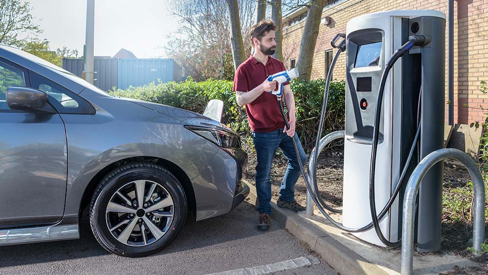 man-charging-his-car-at-the-charging-point.jpg