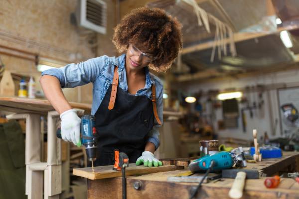 Woman drilling in a workshop