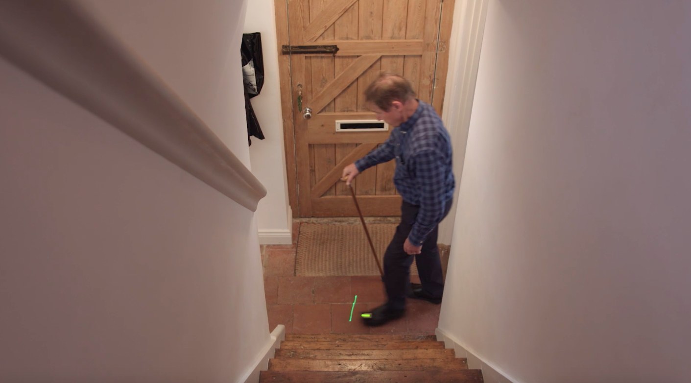 Bruce Jockelson walks down his hallway wearing the 'Path Finder' gadget devised by Lise Pape