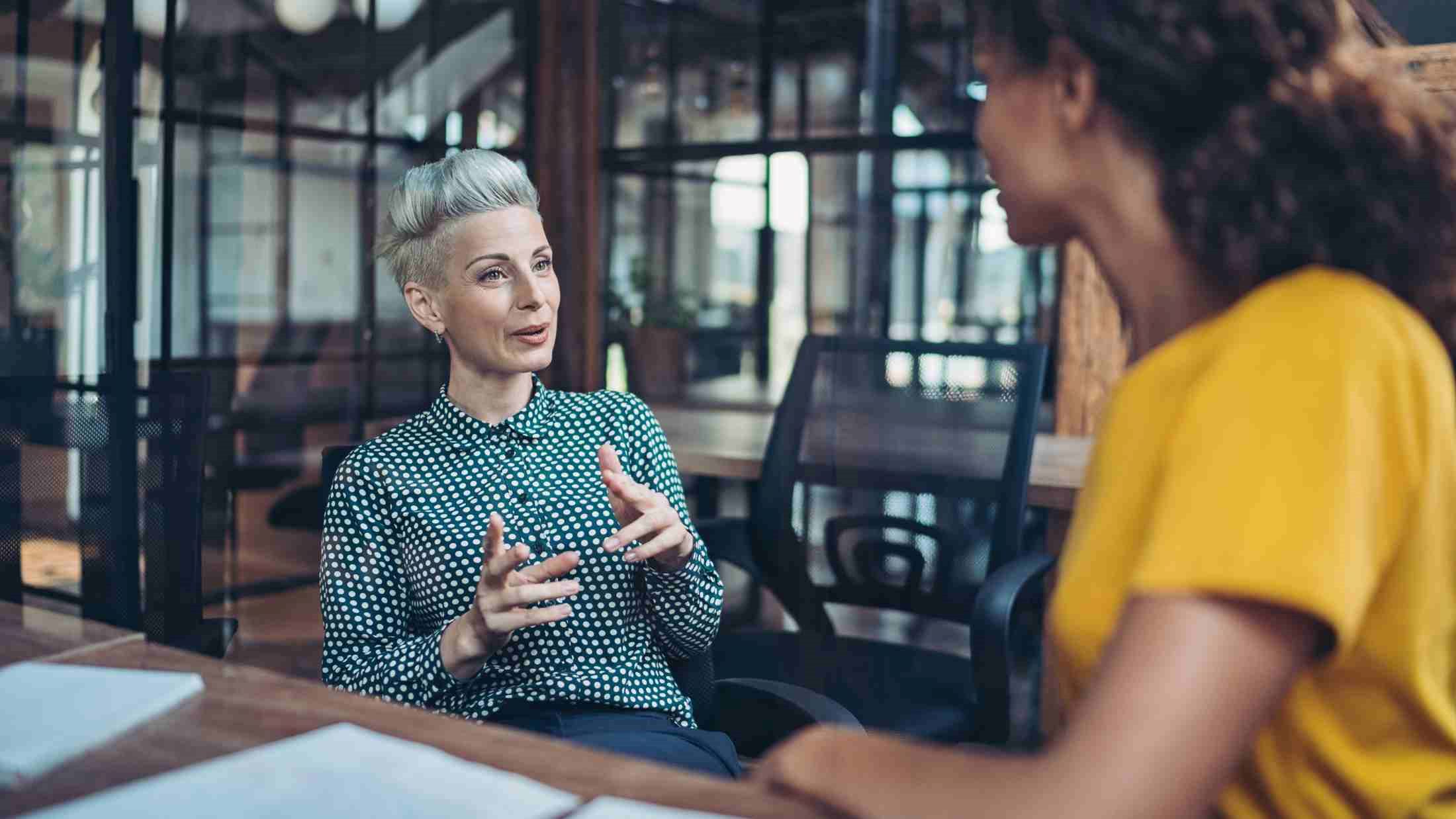 Two businesswomen talking in the office