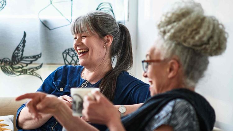 Two women having a coffee break at home