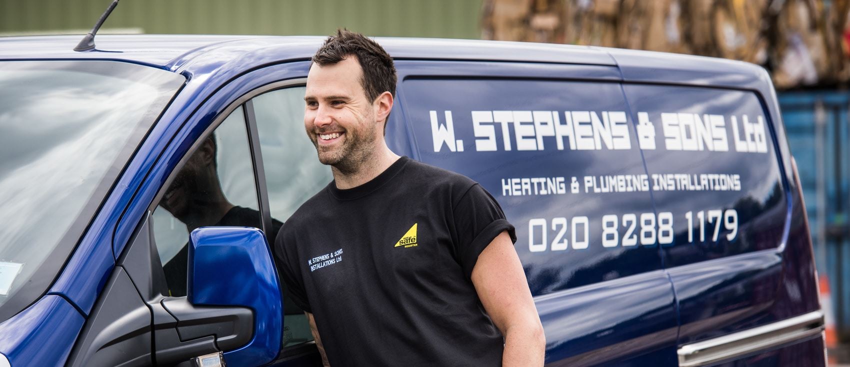 A driver standing next to his van