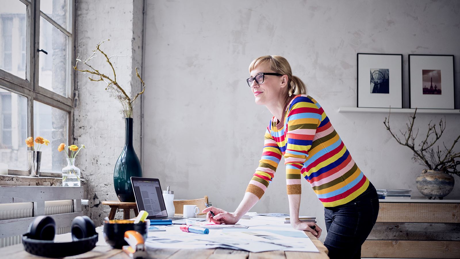 A consultant looks across her desk to the window.