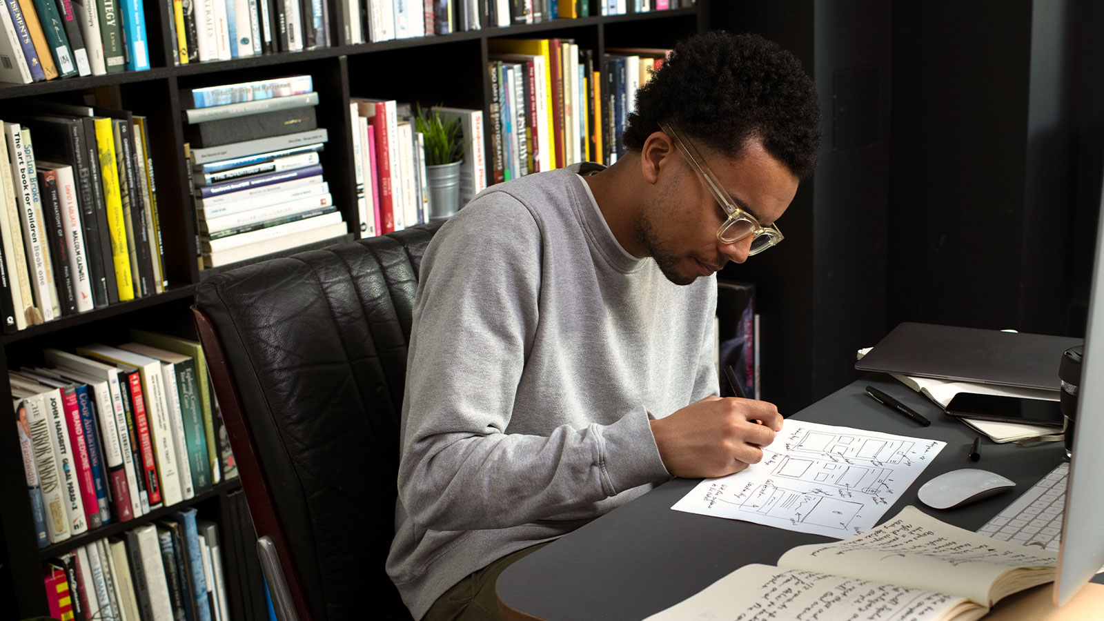 Dominic the designer works at his desk