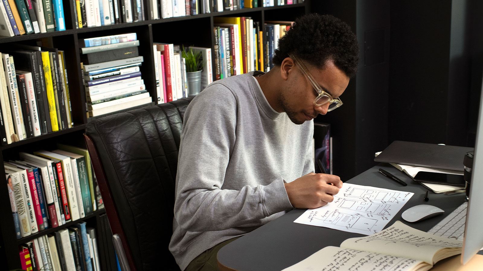 Dominic the designer works at his desk