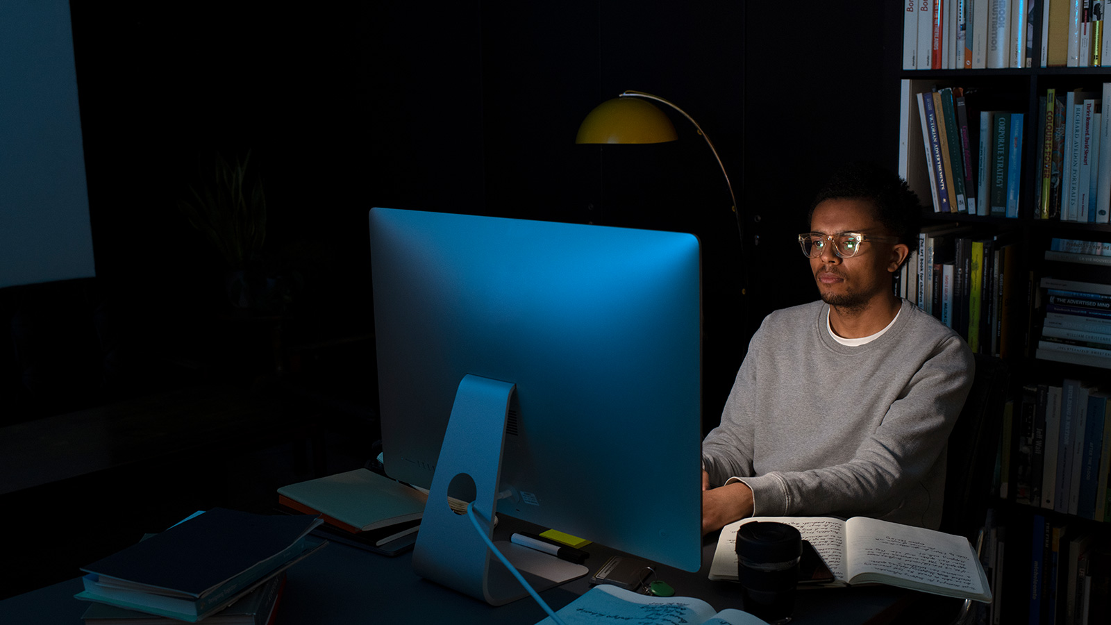 Dominic the designer works on his computer late into the evening