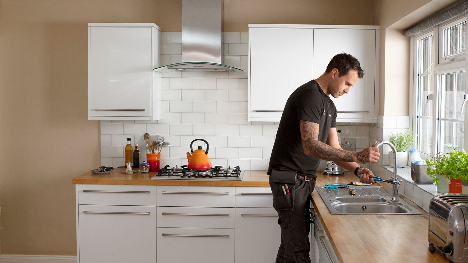 Chris the plumber fixes a sink