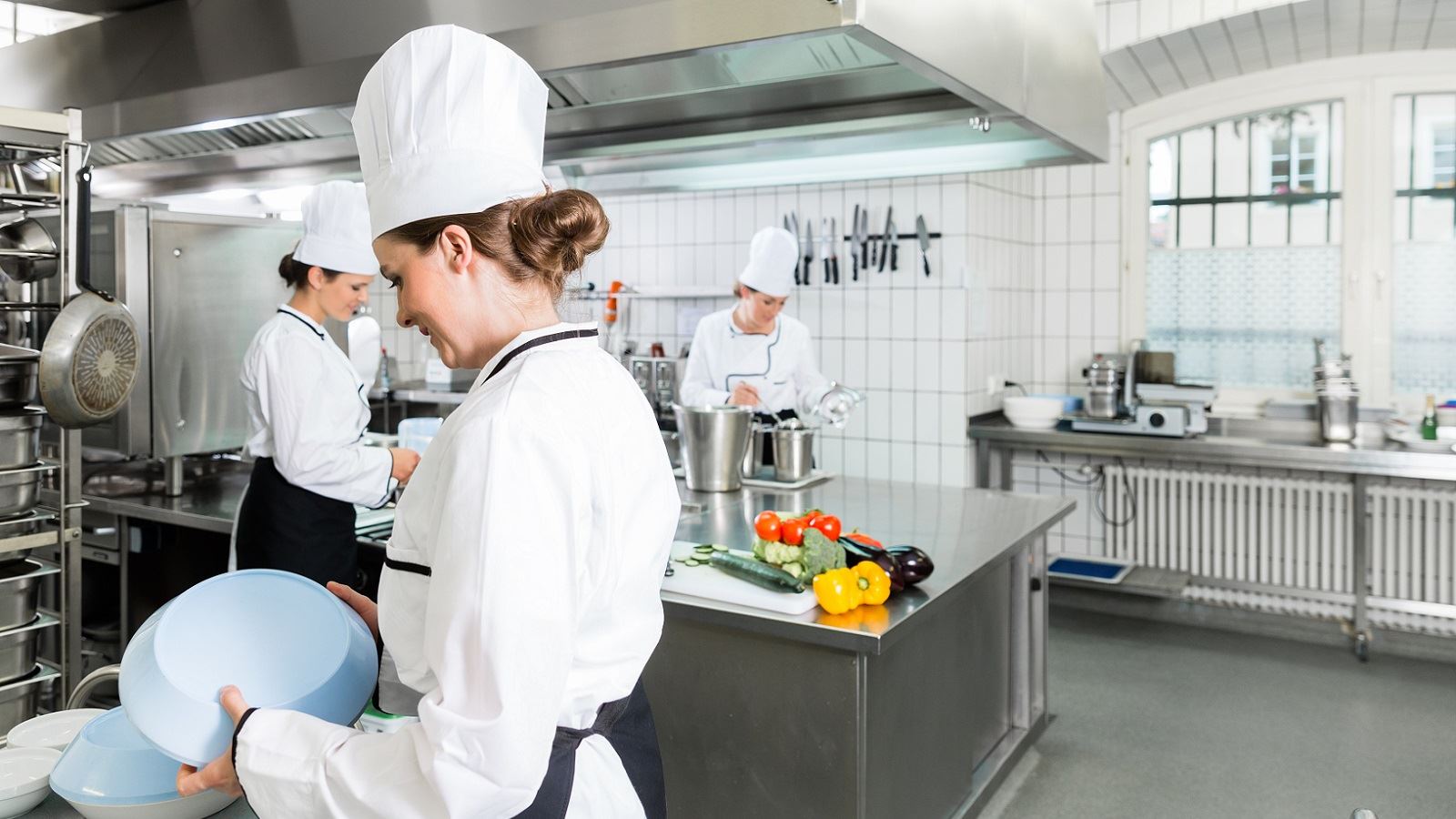 A caterer getting prepared in the kitchen.