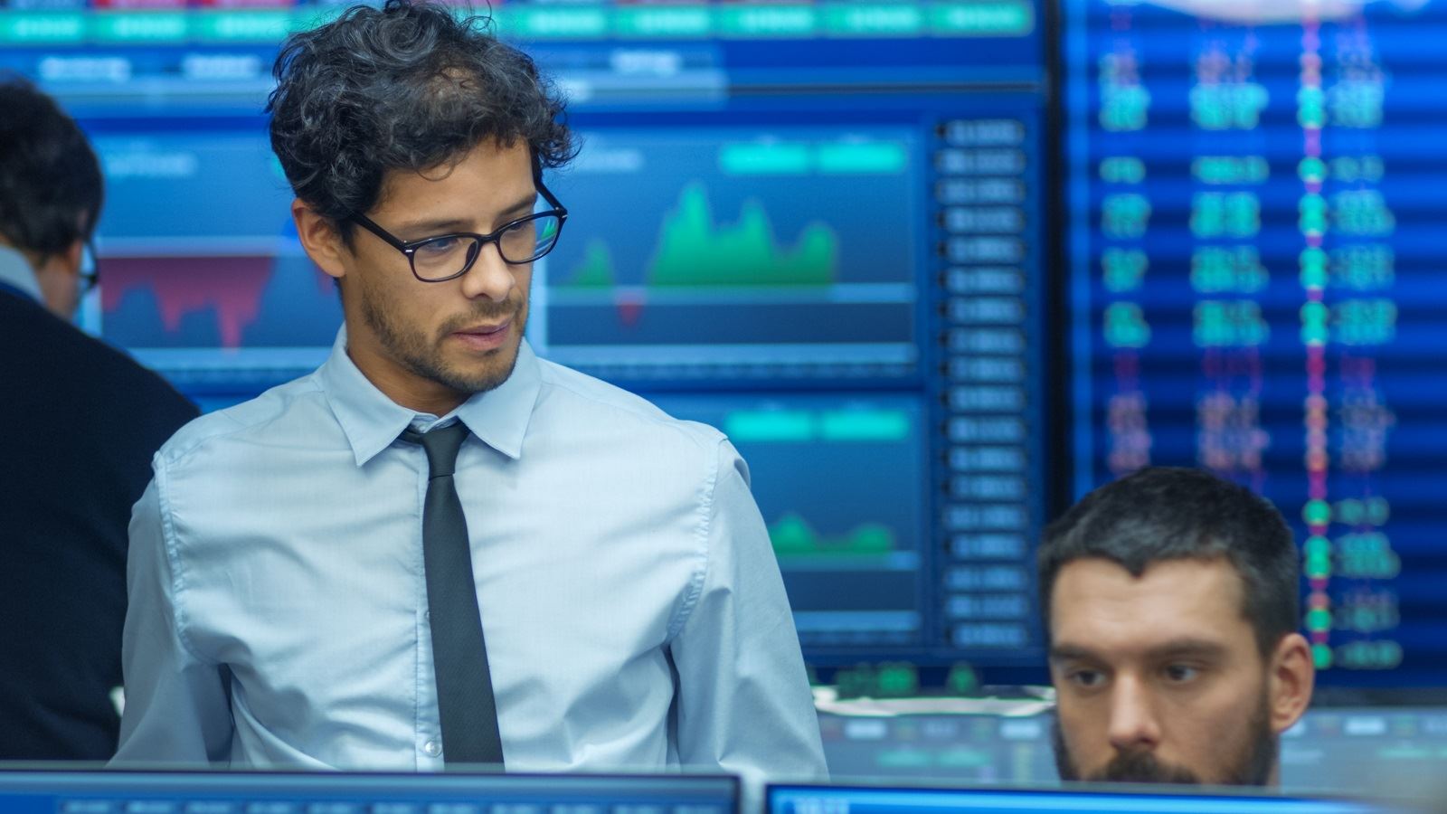 A financial advisor looks at some screens.