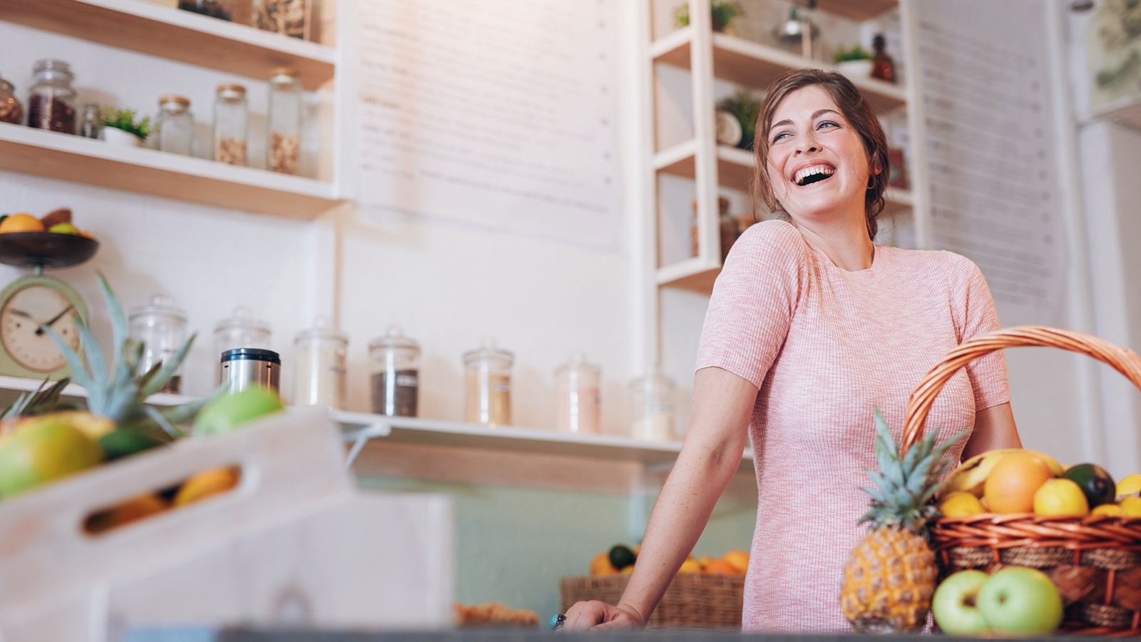 The owner of a deli stands behind a counter