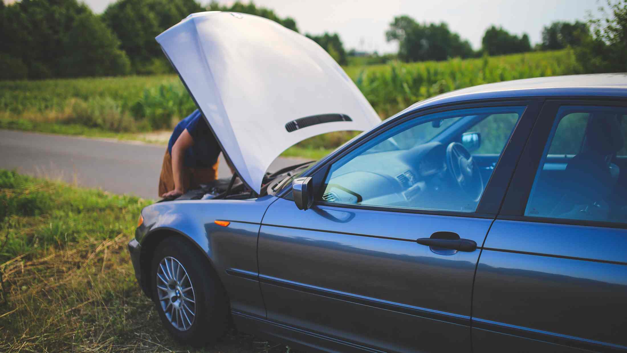 A broken down car at the side of the road