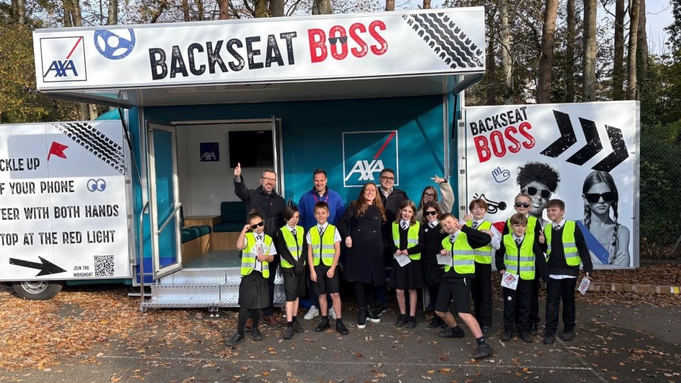 Students stood in front of the AXA Backseat Boss Trailer at the Bournemouth Roadshow
