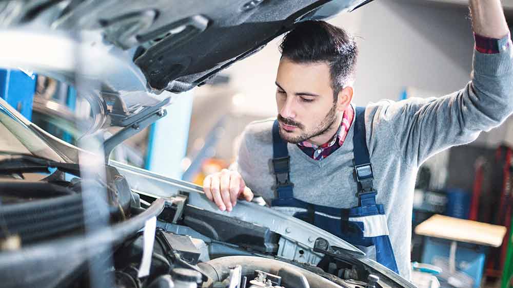 Male mechanic working on car.jpg