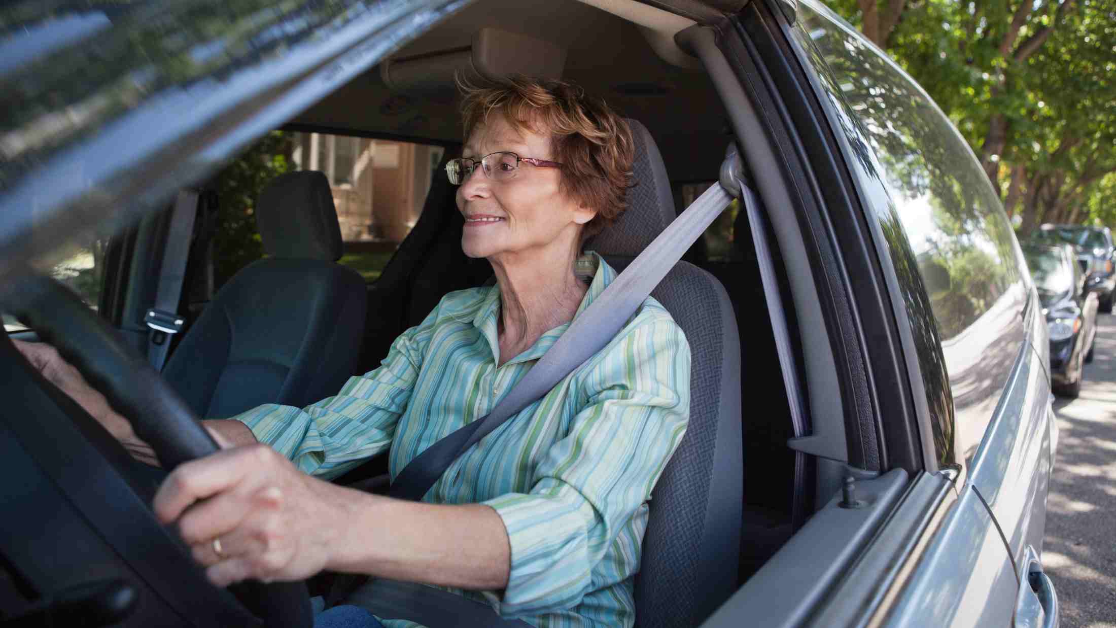 A senior woman driving a car