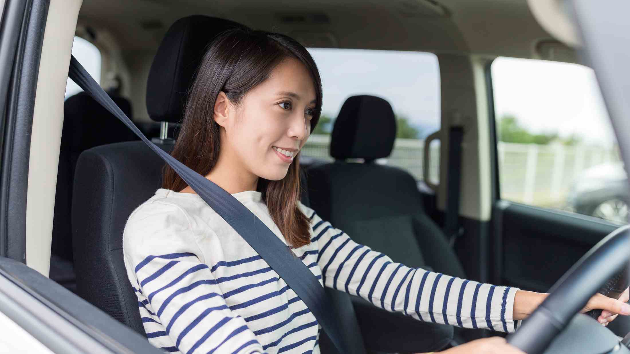 Asian woman driving a car