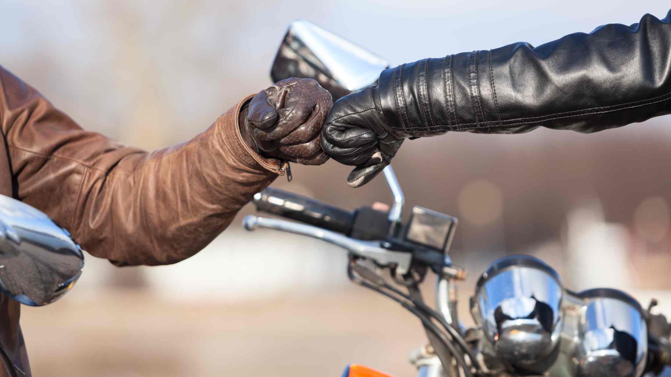 Bikers hands in leather gloves giving high five