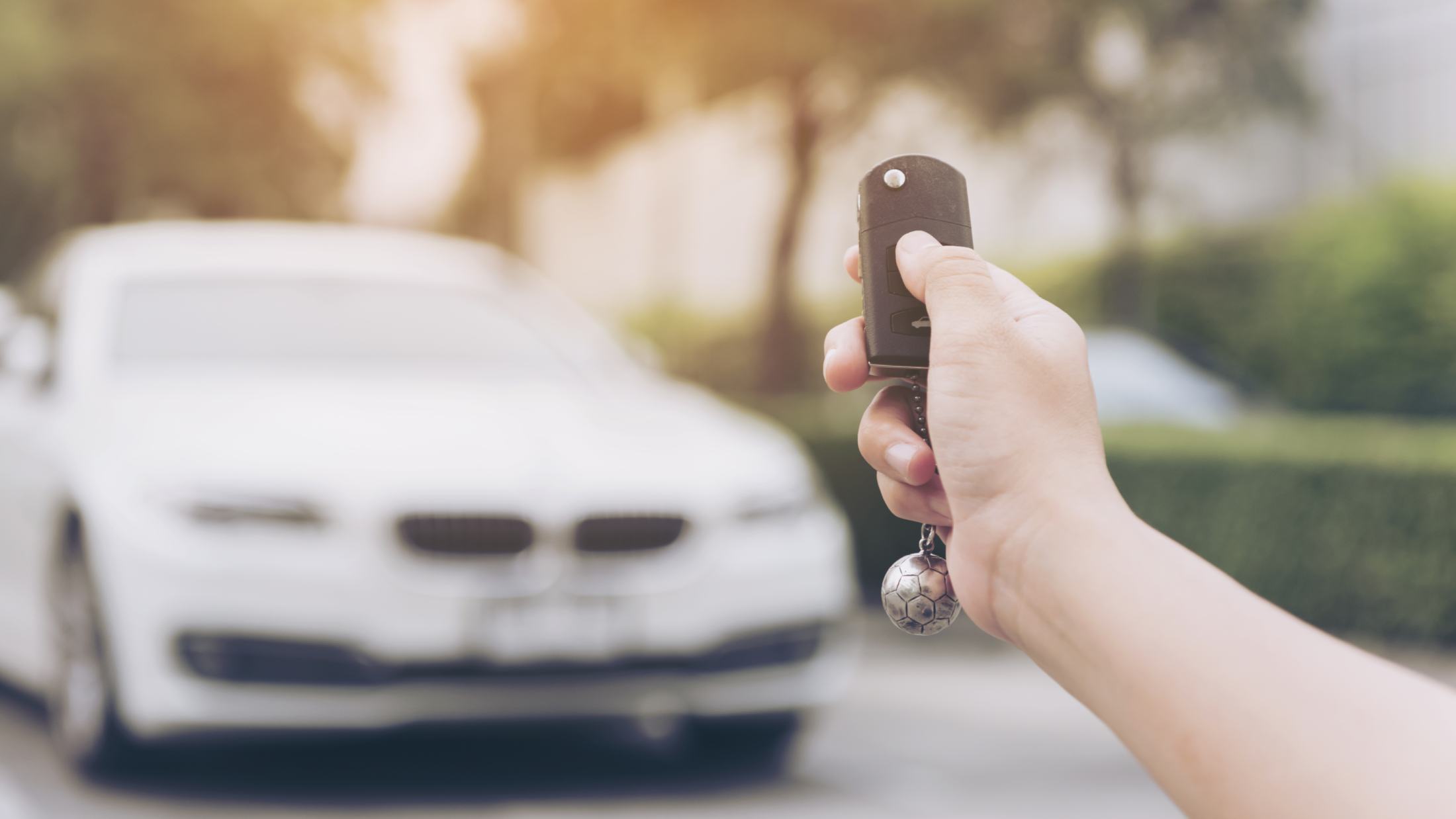 A driver unlocking his car with his fob