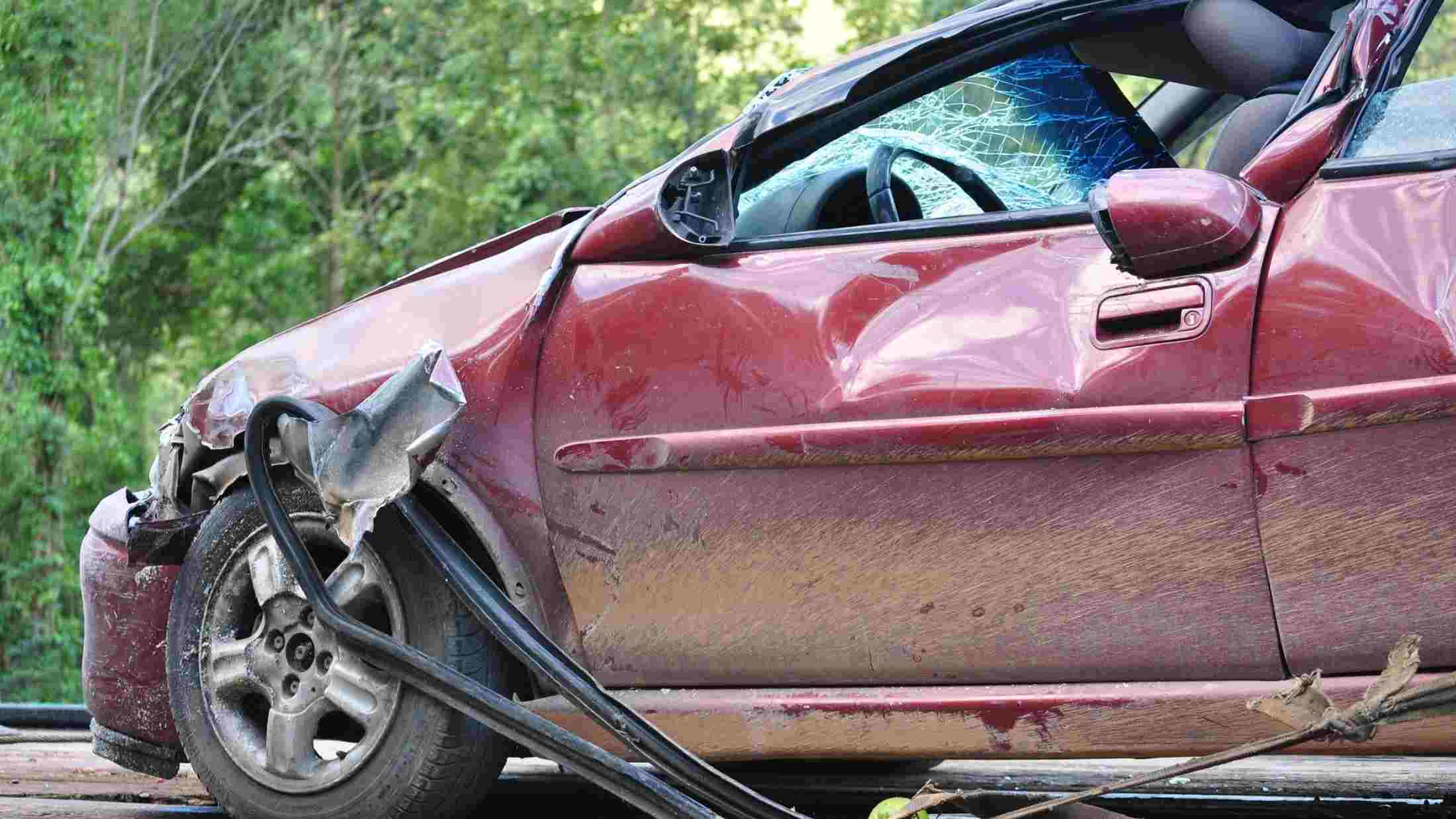 A wrecked car on a recovery trailer