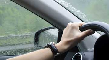 Hand on steering wheel