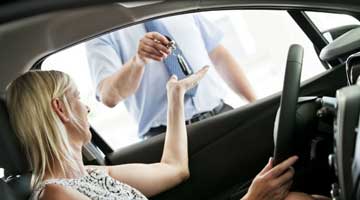 Lady in car collecting keys