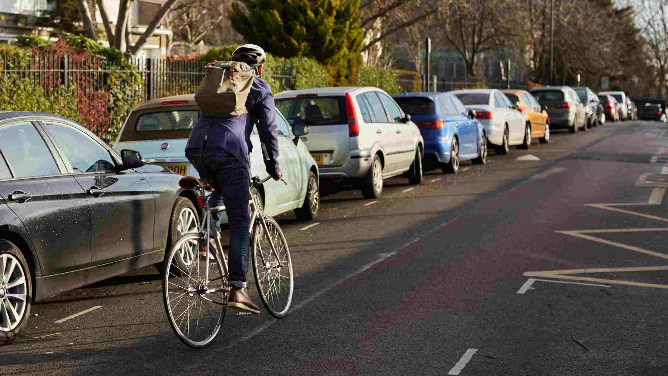 London cycle commuter riding away in neighborhood on way to work