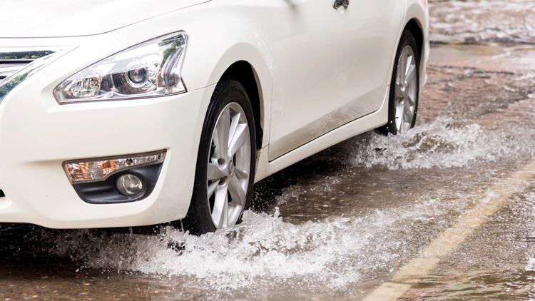 Low view of car driving on a flooded road