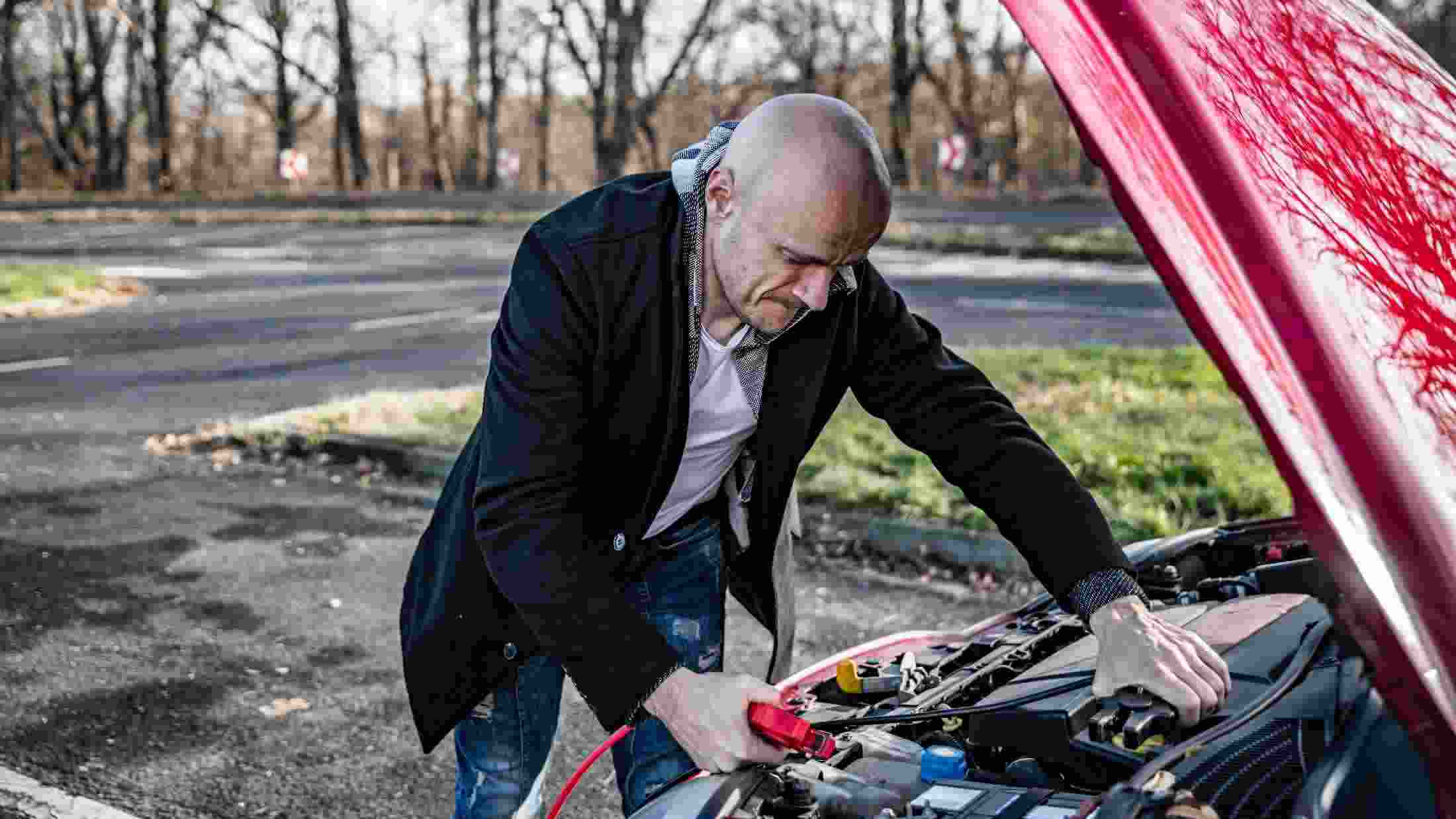Man charging his car battery