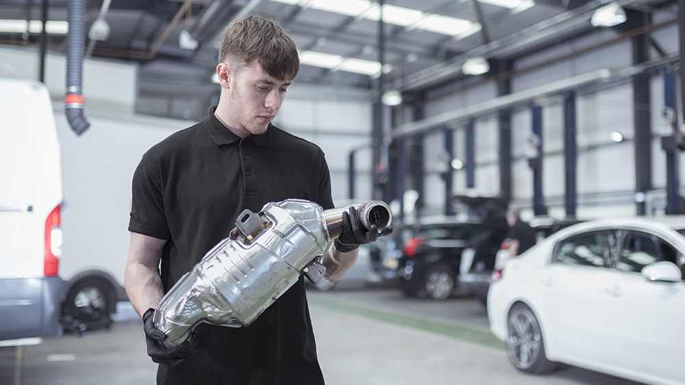 Man holding catalytic converter