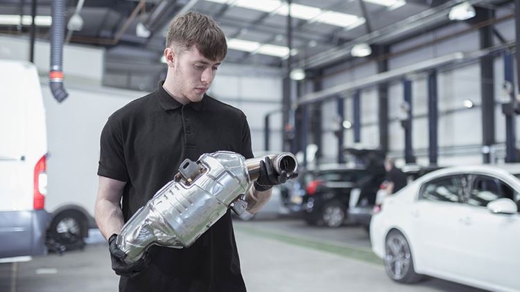 Man holding catalytic converter
