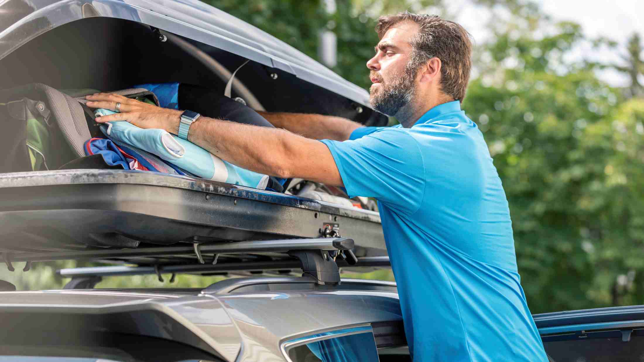 A man packing his car roof rack