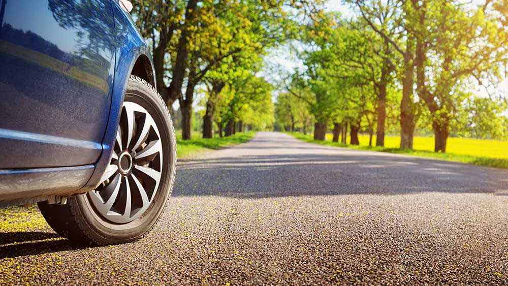 Stationary blue car on a country road