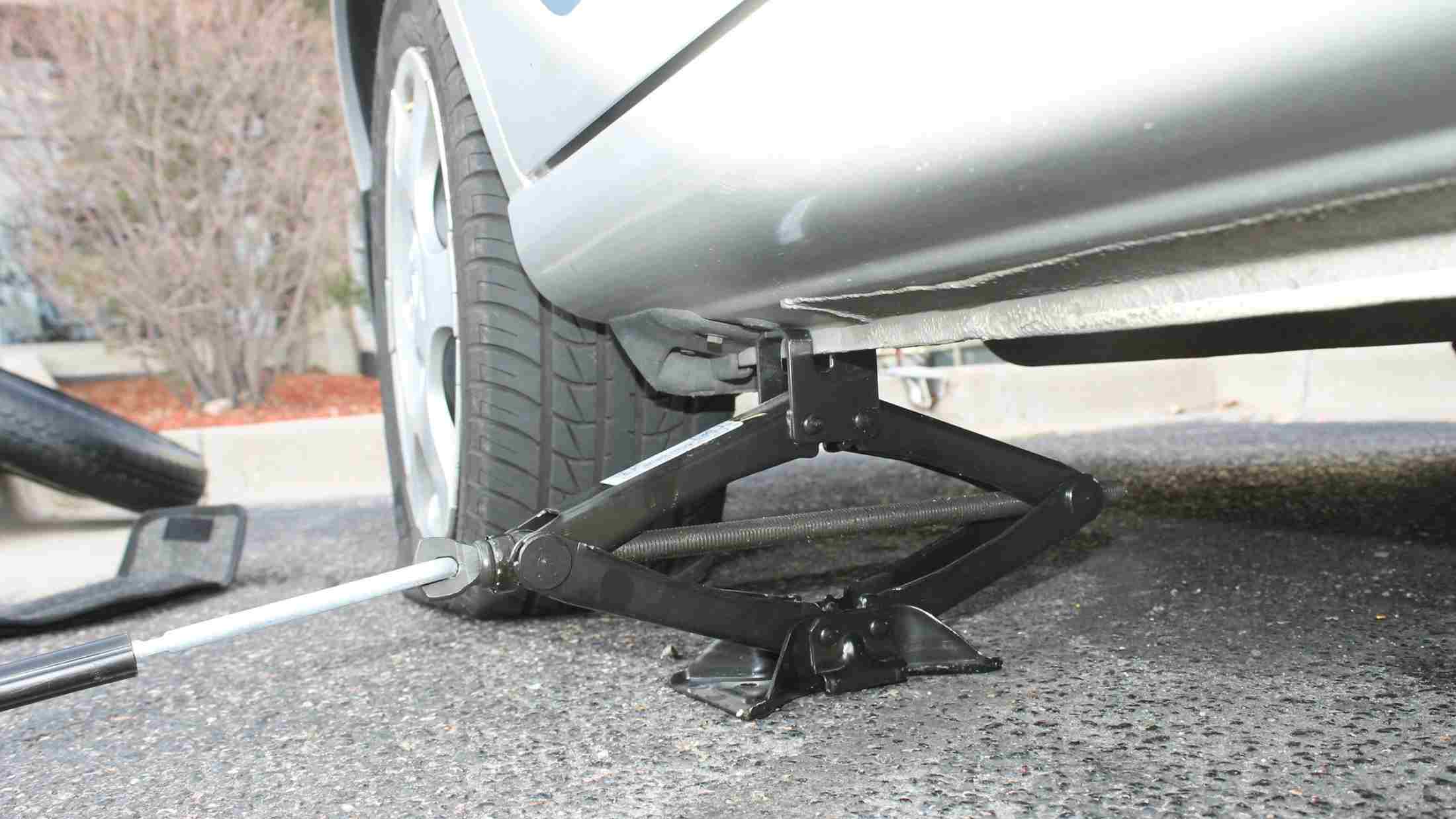 A car jack propping up a car