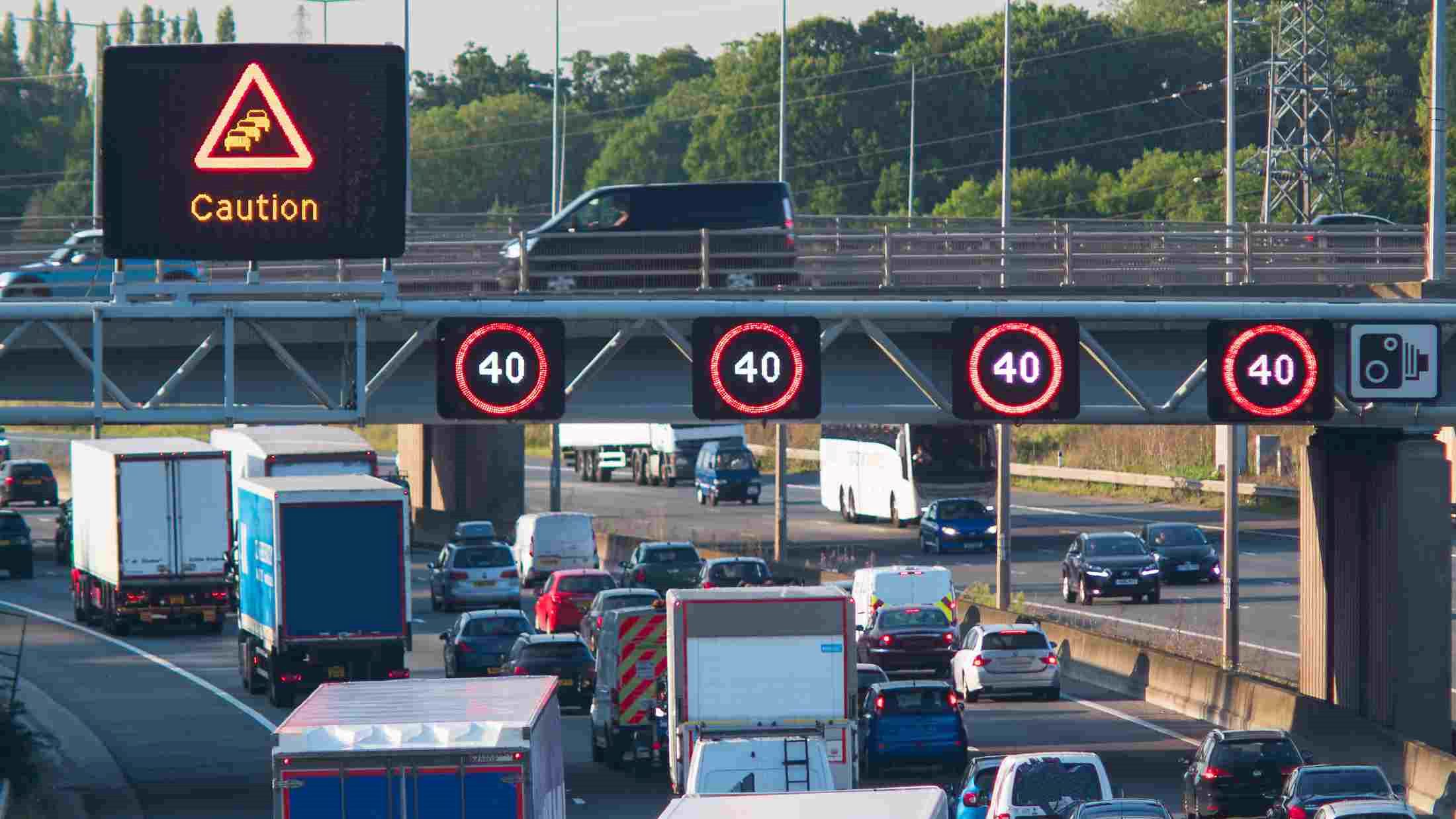 Traffic congestion under warning signs on the m1 motorway